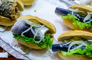 Herring sandwich with onion, cucumber and lettuce