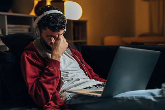 Tired freelancer works from home at night