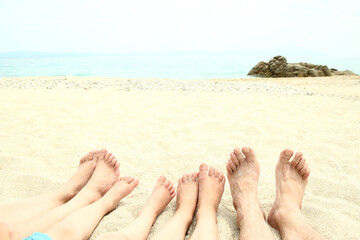 Fototapeta na wymiar beautiful legs in the sand of the sea greece background