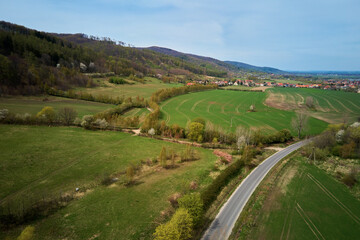 Fototapeta na wymiar Drone flight over mountain village among green agricultural fields, Countryside view, Nature landscape