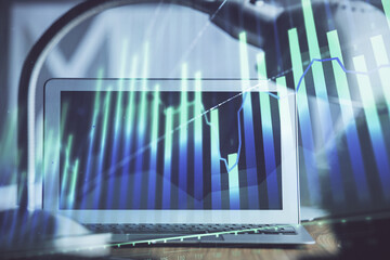 Forex Chart hologram on table with computer background. Multi exposure. Concept of financial markets.