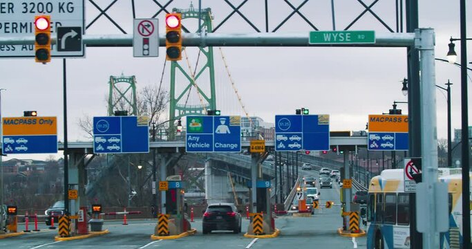 Time lapse of cars entering the toll bridge in Halifax city Canada. Car traffic during rush hour. transfer to down taut across the toll bridge.