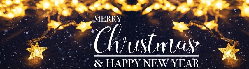 Merry Christmas & happy new Year celebration decoration background banner panorama - Golden star light chain hanging on dark night sky with snowflakes