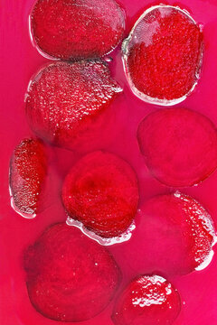 Background of slices of beet on fuchsia surface