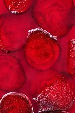 Background of slices of beet on fuchsia surface
