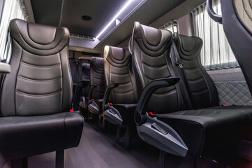 comfortable passenger bus interior with upholstered seats; individual transfer for a group of...