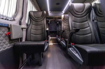 comfortable passenger bus interior with upholstered seats; individual transfer for a group of...
