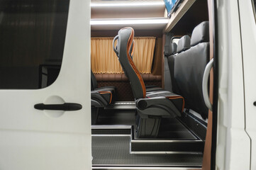 comfortable passenger bus interior with upholstered seats; individual transfer for a group of...