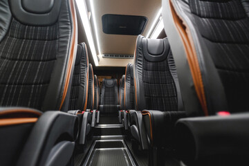 comfortable passenger bus interior with upholstered seats; individual transfer for a group of...