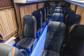 comfortable passenger bus interior with upholstered seats; individual transfer for a group of people; conversion of the interior of a truck; 