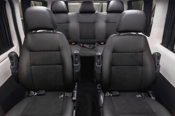 Obraz premium comfortable passenger bus interior with upholstered seats; individual transfer for a group of people; conversion of the interior of a truck; 