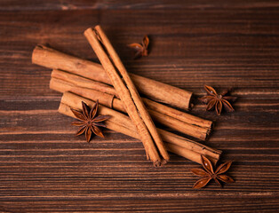 Cinnamon sticks and star anise on wooden background