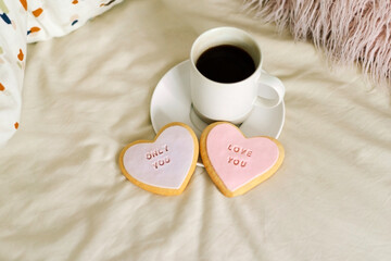 A cup of coffee with delicious cookies with the inscription love you. Celebrating Valentine's Day at home. Concept of Valentine's Day
