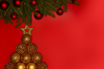 Christmas background . Festively decorated spruce branches on a red banner. Flat lay style.