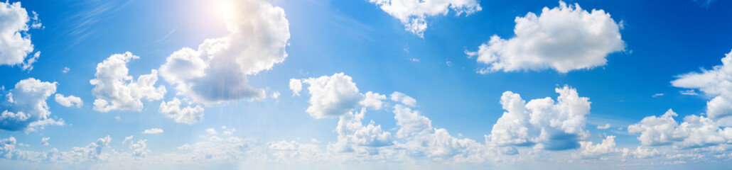 Naklejka na ściany i meble Panorama of blue sky with white clouds