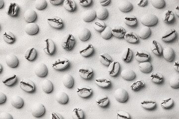 on a white background whole aromatic coffee beans of white color with drops of water. for signboards, labels, flyers, coffee houses, etc.