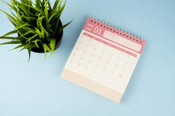 January 2023 desk calendar on blue background flay lay