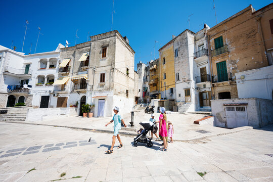 Fototapeta Family of tourists waking in streets Bari, Puglia, South Italy.