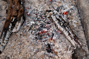 Close-up of the embers of a bonfire with abundant ash.