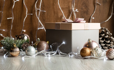 Gift wrapping, Christmas decor and a garland of glowing lights on a wooden table. Festive concept. Gifts for Christmas and New Year.