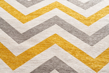 Colorful fabric texture with zigzag serial lines. Close up of interior designed upholstery fabric with geometric pattern print for background. Concept of background texture.