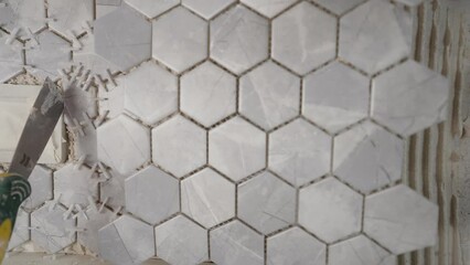 Gray tones with a beautiful texture, square ceramic mosaic tiles on a kitchen backsplash or for decorating a bathroom in a modern interior. Ceramic tile-mosaic for the kitchen. - Powered by Adobe