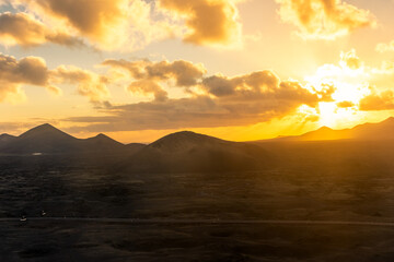 Naklejka na ściany i meble Beautiful sunset over the Volcanos National Park in Lanzarote, Canary Islands, Spain