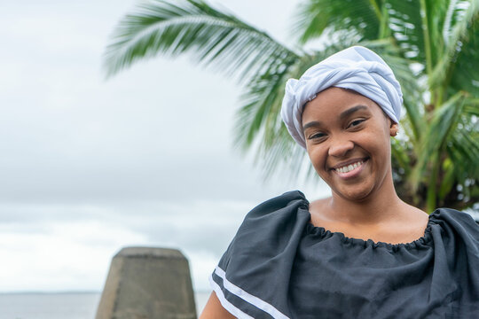 Portrait of a Nicaraguan Caribbean Afro-descendant woman smiling and looking at camera with copy space