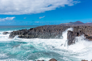 Powerful waves of the Atlantic Ocean crashing on the volcanic cliffs of Los Hervideros in Lanzarote, Canary Islands, Spain