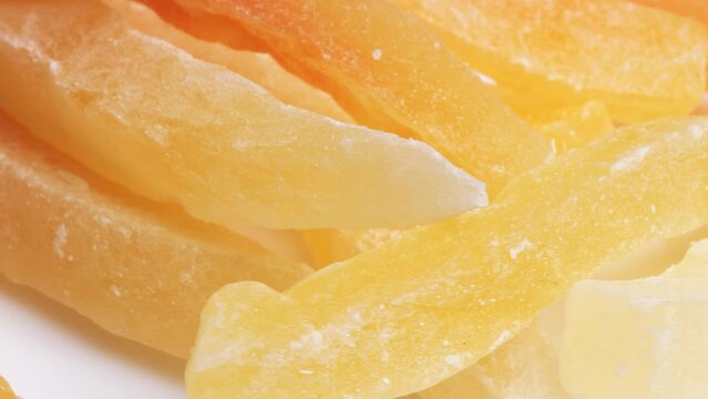 Sweet dried papaya fruit. Close-up of papaya pieces rotate close-up