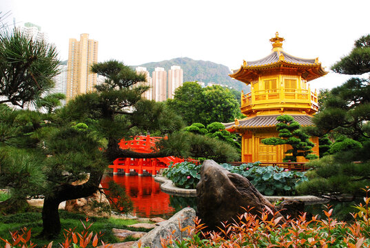 Nan Lian public garden in the city center, view of the Pavilion of Absolute Perfection also known as golden or octagonal pavilion. Residential skyscrapers in the background. Hong Kong, China.