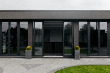 Modern restaurant. Entrance to the restaurant. Courtyard in front of the restaurant. Glass entrance.