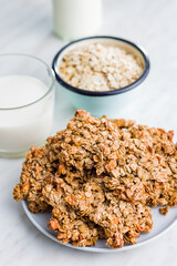 Sweet oatmeal cookies on plate on kitchen table.