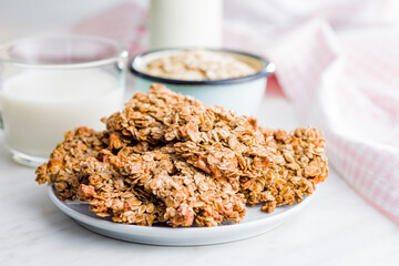 Sweet oatmeal cookies on plate on kitchen table.