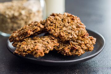 Sweet oatmeal cookies on plate on kitchen table.