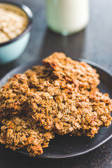 Sweet oatmeal cookies on plate on kitchen table.