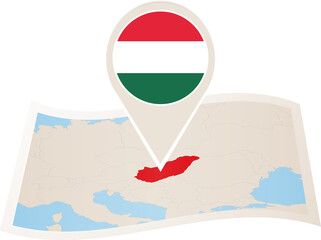 Naklejka premium Folded paper map of Hungary with flag pin of Hungary.