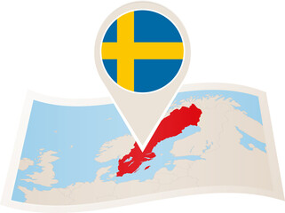 Folded paper map of Sweden with flag pin of Sweden.
