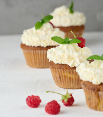 Baked cupcakes with white butter cream on the table, delicious dessert
