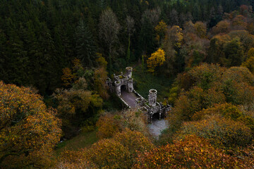 Aerial drone view of Ireland's Ballysaggartmore Towers . Medieval bridge in the forest, Lismore, County Waterford.