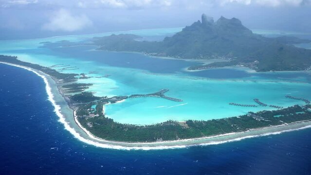 4K Aerial Drone footage of whole island of Bora Bora, Tahiti, French Polynesia. Turquoise blue lagoon in Bora Bora. Luxury travel vacation, romantic getaway, honeymoon exotic destination. Otemanu.