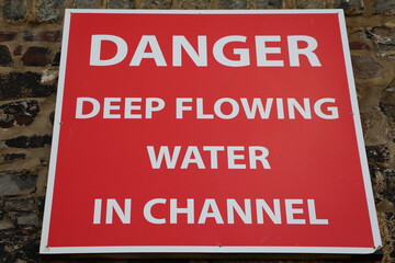 Danger deep flowing  water in channel, Cornwall UK