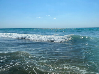 Waves, splashes of water on the beach at the sea on vacation in a tourist warm eastern tropical country southern paradise resort on vacation. The background