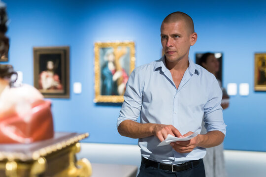 European Man Admiring Art Work In Museum