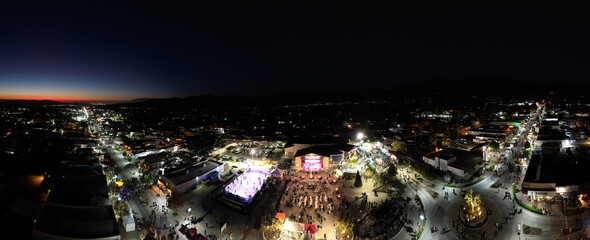 Fototapeta na wymiar Yucaipa, California, as Seen from a Drone UAV Aerial View as the Town Celebrates Winterfest Winter looking at the Performing Arts Center and the Ice Rink with Large Crowds of People