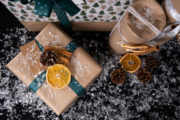 Christmas gifts packed in paper packaging sprinkled with snow