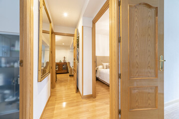 Distributor corridor of an urban residential house with oak woodwork to match the floors and skirting