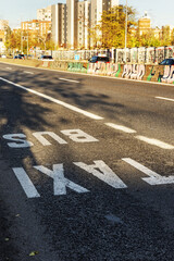 exit road from a city with lane painted on the road for bus and taxi