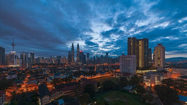 High Angle Time lapse view of  busy city streets and golden sunrise against a skyline in Kuala Lumpur, Malaysia. Prores 4KUHD.