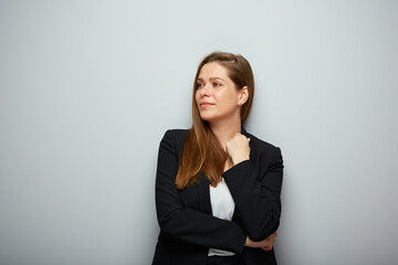 Smiling business woman in black suit looking away isolated portrait. - 553319381
